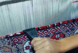The weft pushes tight each line of knots to make it secure.